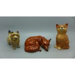 Three Beswick models; laying fox, cat and Norfolk Terrier