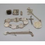 A silver pendant and chain, a small silver ingot pendant, a silver bracelet, a silver ring, a coin