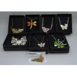 Seven butterfly necklaces and a dragonfly necklace, (8)