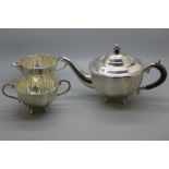 A white metal three piece tea service, foreign hallmarks, 668g