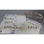 A collection of 48 Royal Mail mint stamp packs and first day covers