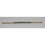 An 18ct gold, blue topaz and diamond bracelet, 14.5g, 18cm