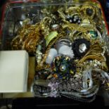 A tin of costume jewellery