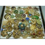 A collection of brooches lacking pins, (for repair or repurposing)