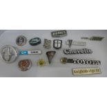 A collection of fifteen car badges