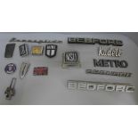 A collection of assorted car badges, Bedford, Mini, etc.