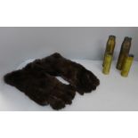 A pair of WWI flying gloves and four brass shell casings