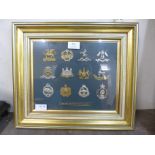 A framed set of twelve British military cap badges