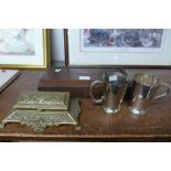 A brass stamp holder, a pair of plated mugs and a small oak box