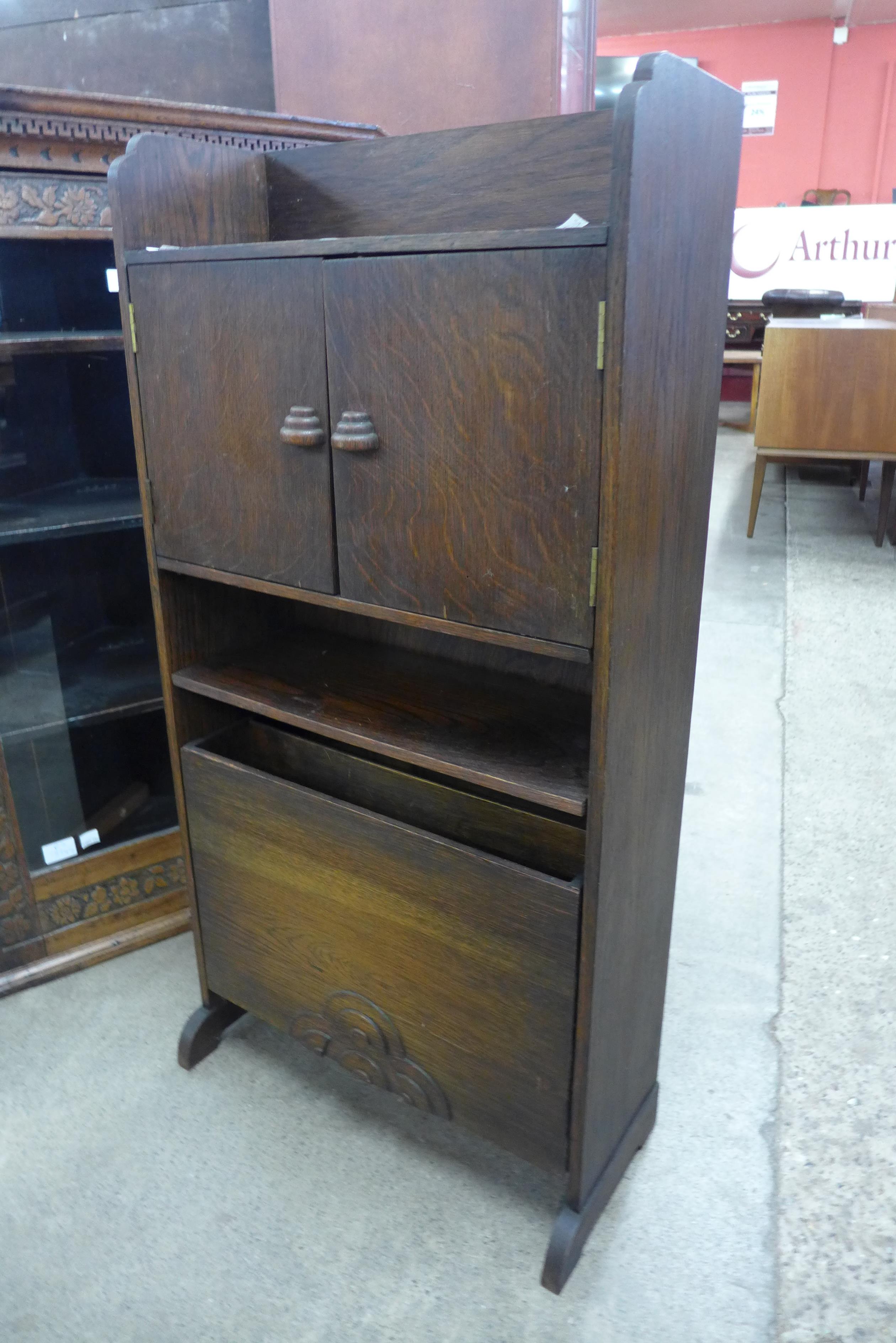 An early 20th Century oak newspaper stand