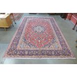 A Persian red ground Kashan rug, 363 x 249cms