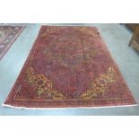 An early 20th Century Persian red ground Herris rug, 280 x 185cms
