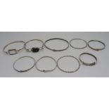 Seven silver bangles and two other bangles, silver 51g, some small sizes