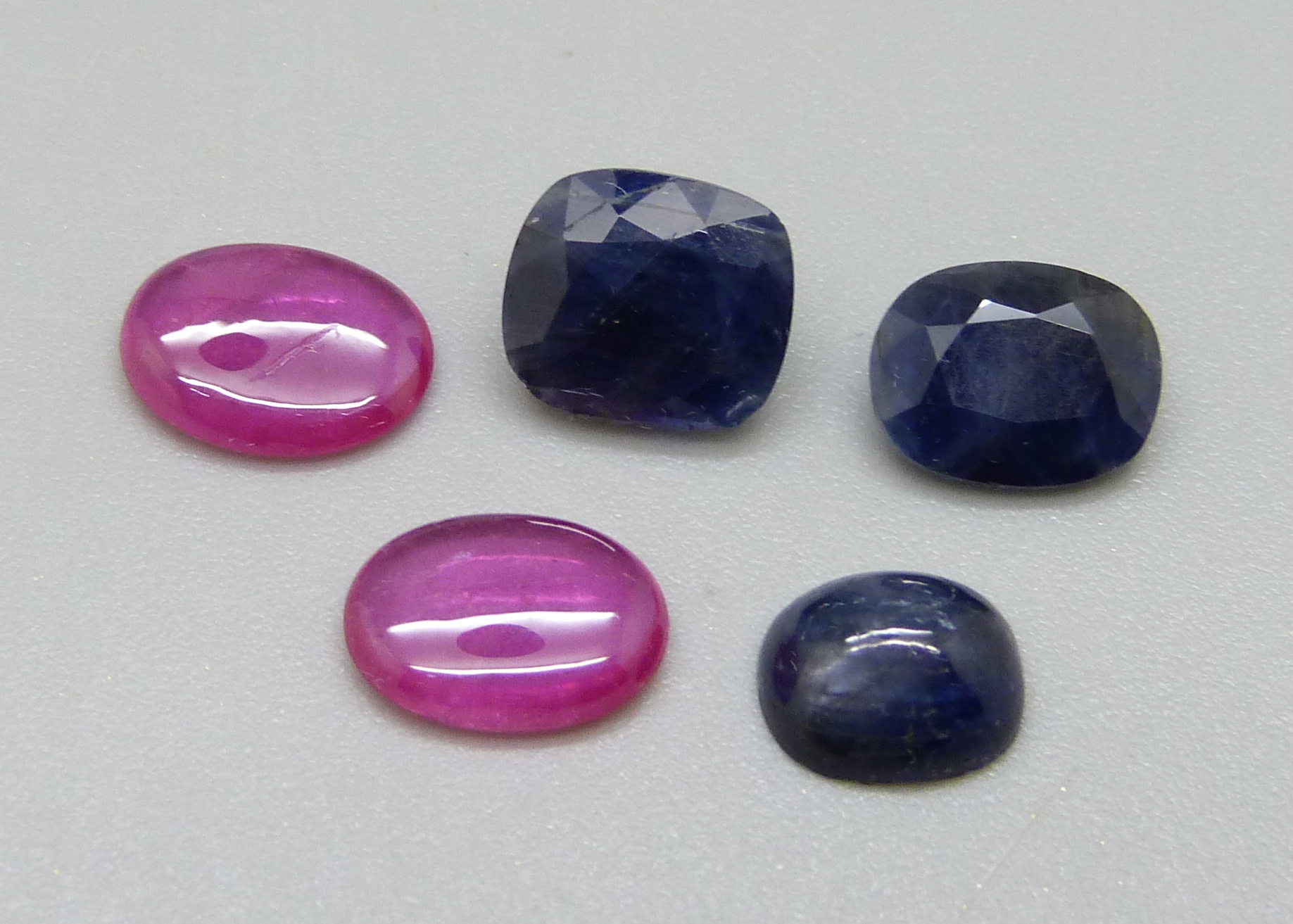 Unmounted rubies and sapphires, (2 and 3)