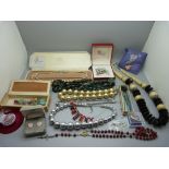 A collection of costume jewellery including hat pins, necklaces, etc.