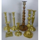 A pair of brass candlesticks and five other candlesticks