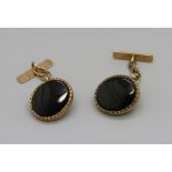 A pair of 9ct gold and onyx set cufflinks, 3g