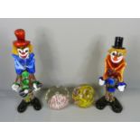 Two Murano glass clowns and two glass paperweights