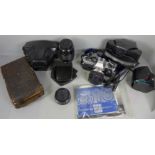 An Olympus OM10 SLR camera with manual adaptor and instructions, an auto Teleplus lens, Vivitar 35-