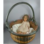 A mid 20th Century composition doll and a wicker basket