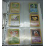 Forty base set Pokemon cards including holographic Hitmonchan, Gyarados, forty-one Fossil