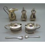 A pair of silver peppers, two silver mustards and a silver cream jug, 256g