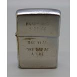 A Zippo lighter with inscription, 'Harry McS, 3-23-66, One Year, One Day At A Time', from Vietnam