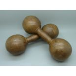 A pair of antique wooden dumbbells, circa 1900/1910, stamped Gamages of Holborn, 24cm, 851g