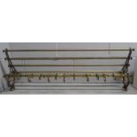 An antique brass railway carriage luggage rack, length 91cm with decorative brackets