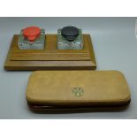 A wooden ink stand with twin glass inkwells and a geometry set