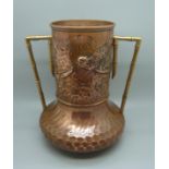 A late 19th Century Arts and Crafts copper and brass twin-handled vase