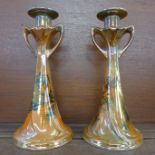 A pair of Shelley England orange lustre candlesticks with countryside scenes, 26.5cm