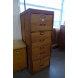 A pine and ply wood four drawer filing cabinet