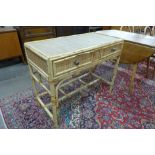 A bamboo and rattan two drawer desk