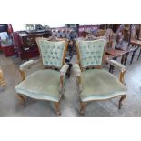 A pair of late Victorian carved walnut and green fabric upholstered open armchairs