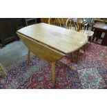 An Ercol Blonde elm and beech Windsor drop leaf table