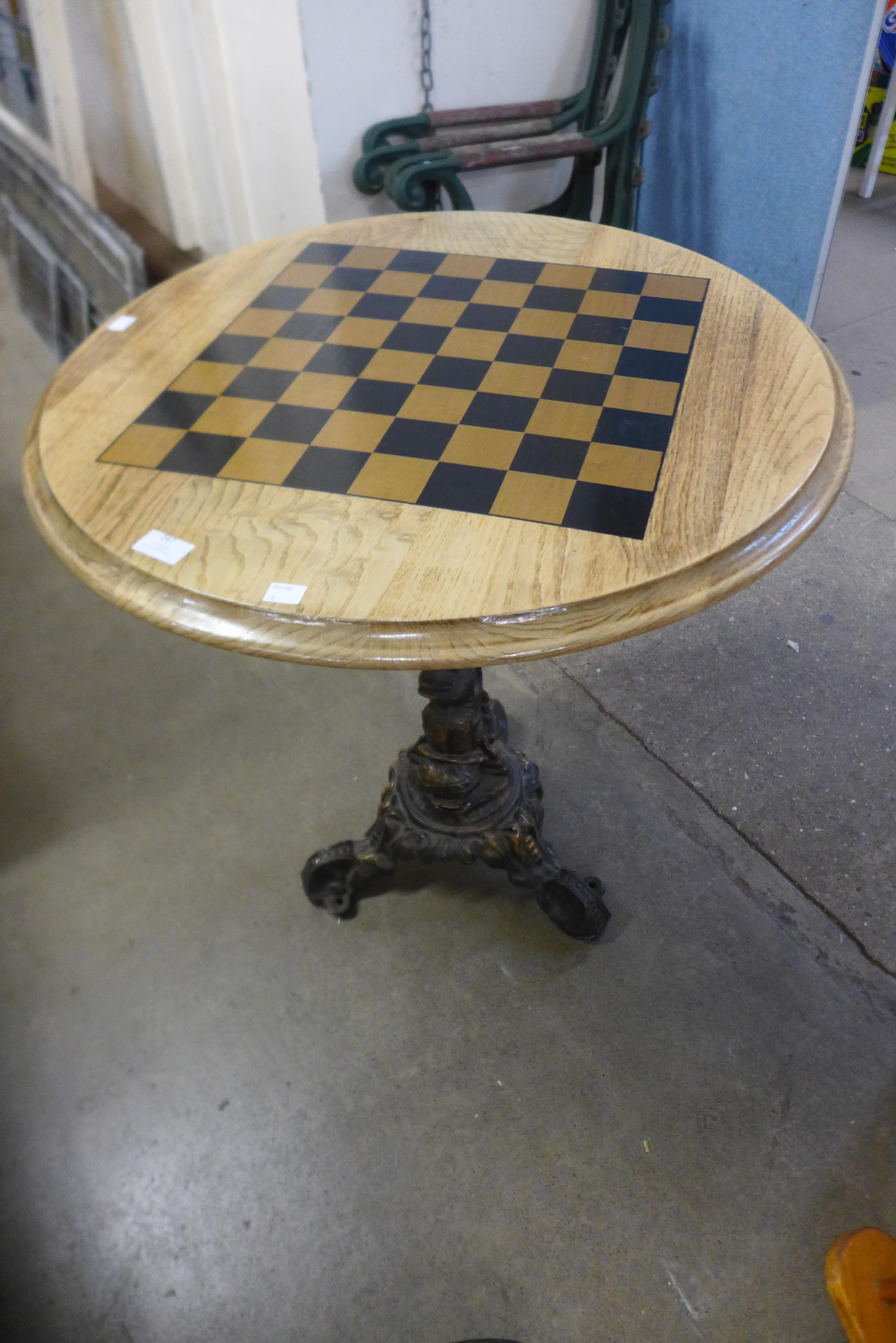 A cast iron pub table, with chess board top