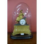 A 19th Century French glass domed gilt metal mantle clock, on ebonised stand