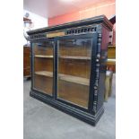 A Victorian Aesthetic Movement ebonised and parcel gilt two door bookcase