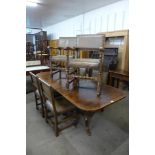 A George III style oak pedestal dining table and a set of six oak and leather upholstered dining