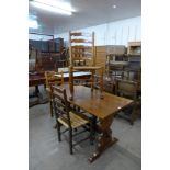 An oak refectory table and a set of four elm rush seated ladderback chairs (one chair a/f)