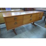 An Austin Suite teak six drawer sideboard