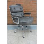 A 2008 Vitra chrome and grey leather ES104 revolving desk chair, designed by Charles Eames