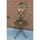 An Arts and Crafts copper and brass spirit kettle, on wrought iron stand