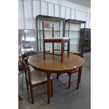 A McIntosh mahogany circular extending dining table and four chairs