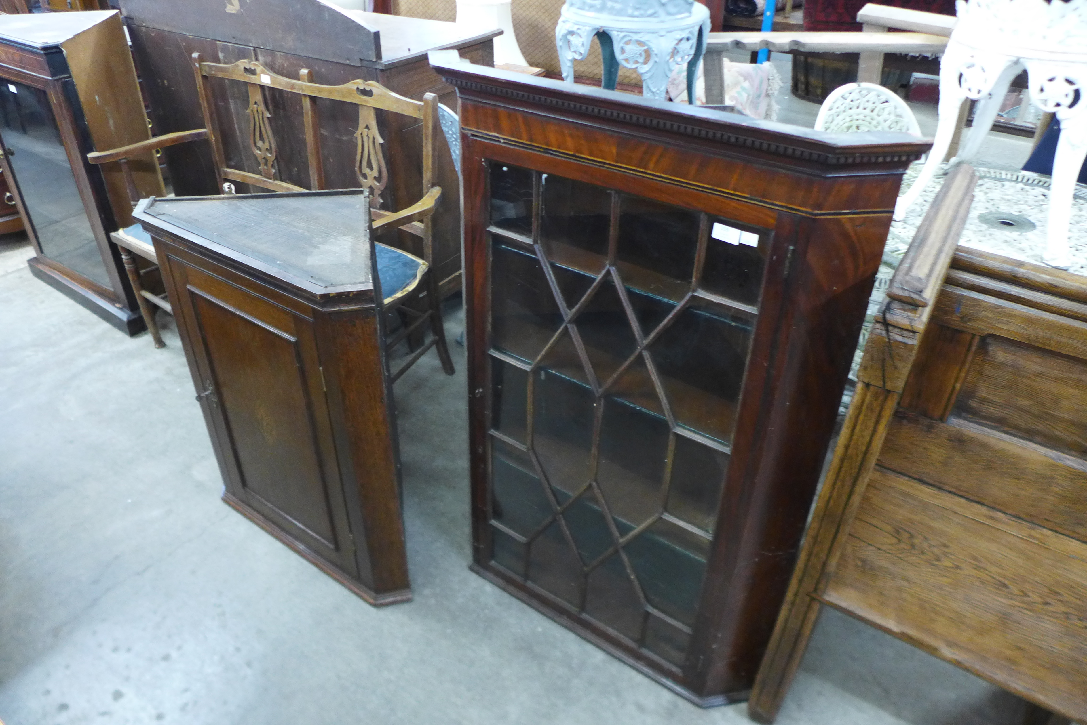 A George III inlaid oak splay front wall hanging corner cupboard and one other