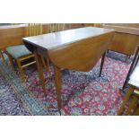 A teak drop leaf table