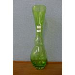 A tall green studio glass vase