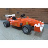 A limited edition Ferrari F1 Indy ride on car, Formula 1 W/12 volt battery power - with charging