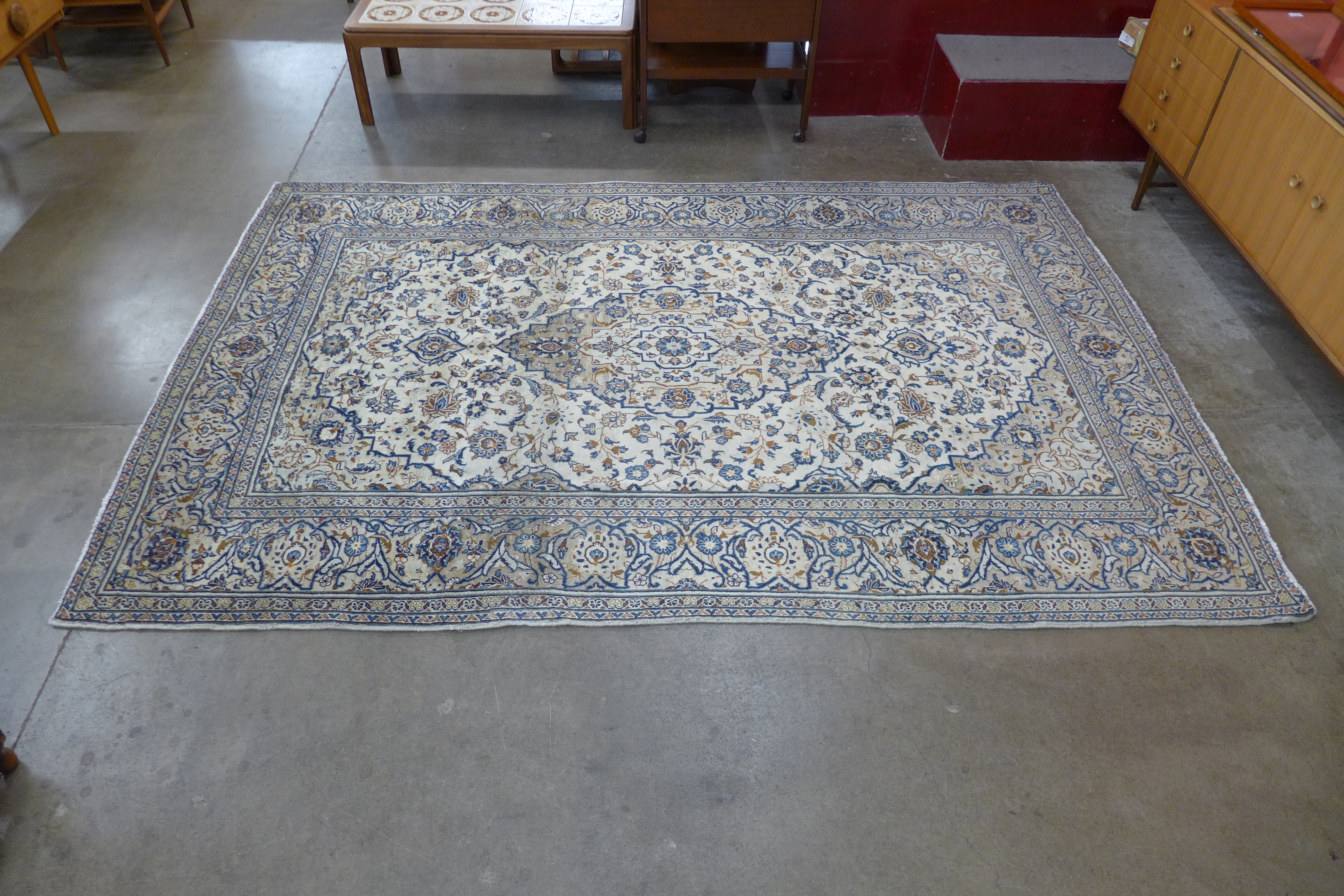 A Persian Kashan cream ground rug, 292 x 195cms